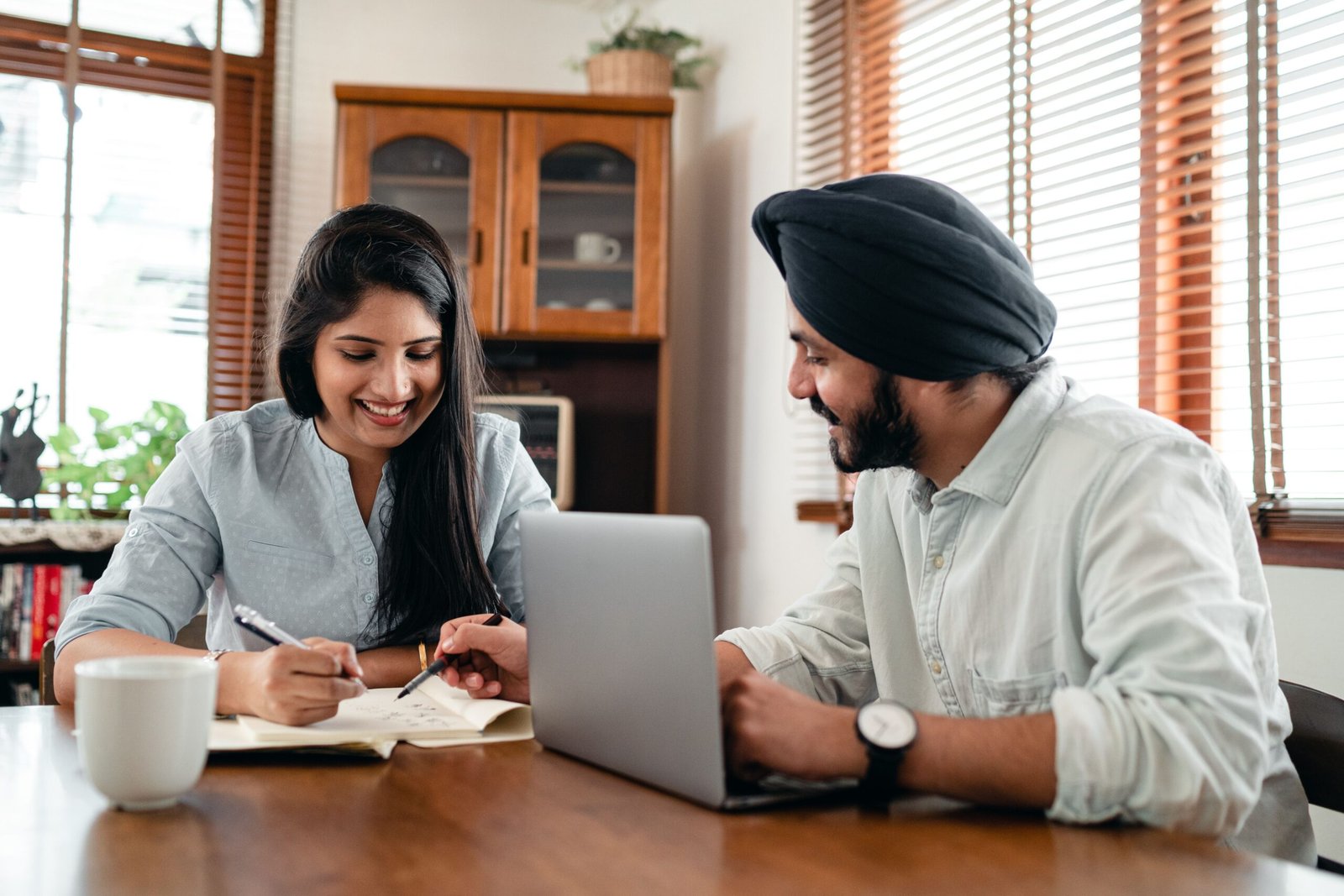 Colleagues collaborating around a laptop